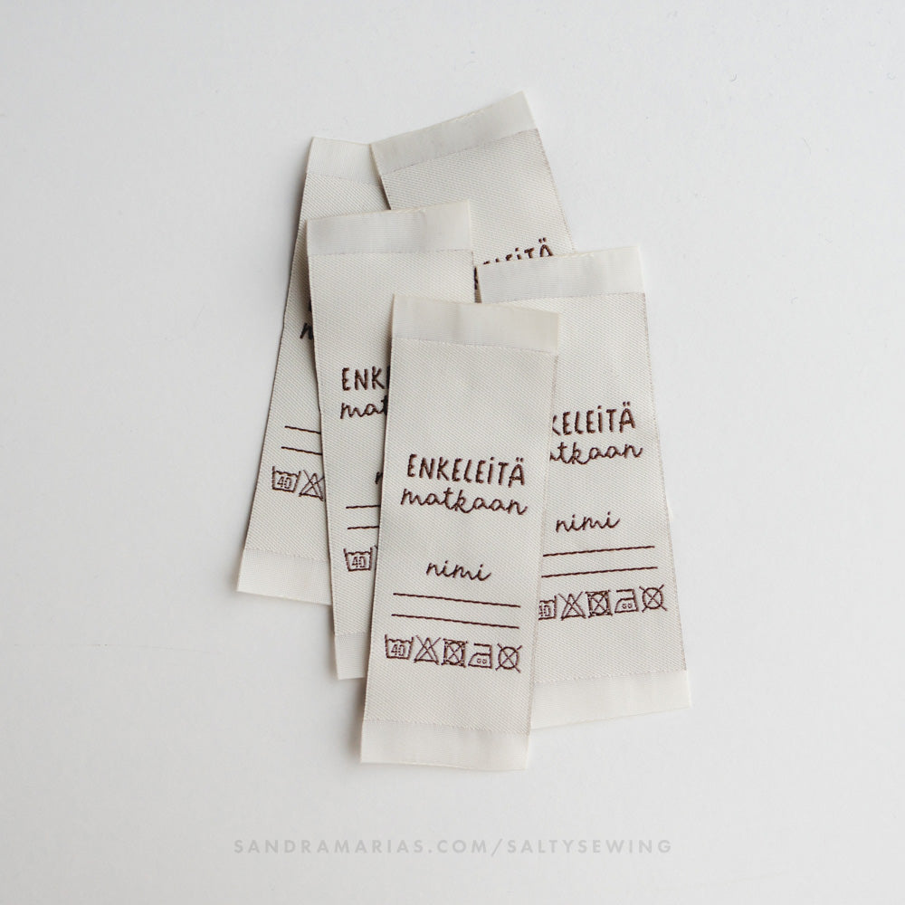 Woven label - Enkeleitä matkaan